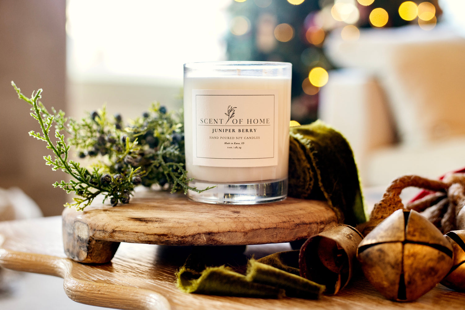 Juniper Berry candle by Scent of Home — hand-poured soy candle with juniper and pine notes, surrounded by greenery and holiday decor.