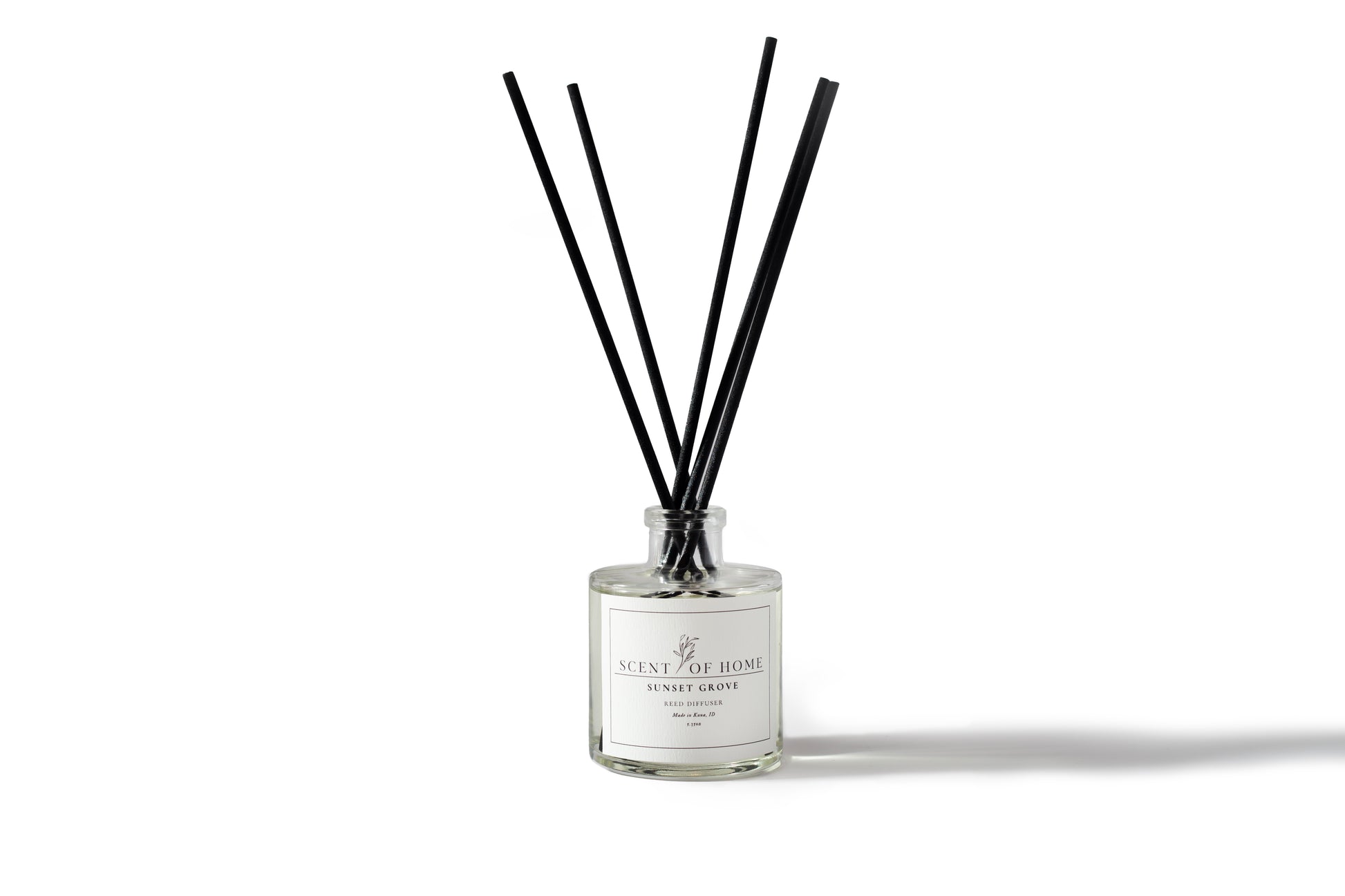 Scent of Home Sunset Grove reed diffuser with black reeds on white background — hand-poured home fragrance with notes of orange, coconut, and sandalwood