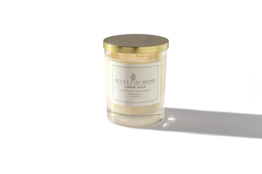 Scent of Home Amber Noir 10oz candle in clear glass vessel with gold lid — hand-poured soy candle offering a warm, luxurious fragrance.