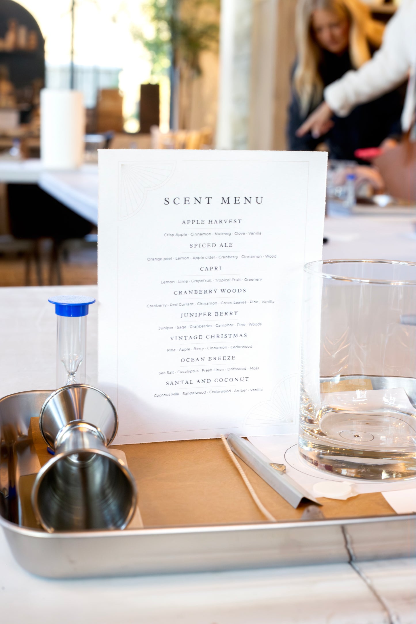 Candle pouring station set up for a Scent of Home event — featuring a scent menu, glass vessel, and fragrance tools ready for guests to create their own candle.