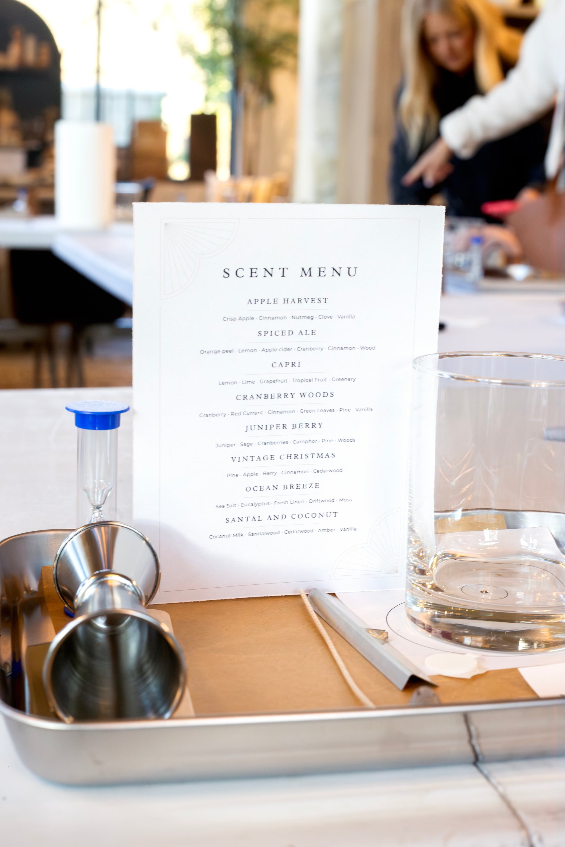 Candle pouring station set up for a Scent of Home event — featuring a scent menu, glass vessel, and fragrance tools ready for guests to create their own candle.