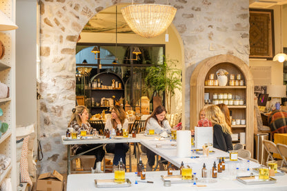 Guests enjoying a Scent of Home candle pouring class at Robert & Wallace — a cozy, hands-on event surrounded by candles, fragrance oils, and beautiful home décor