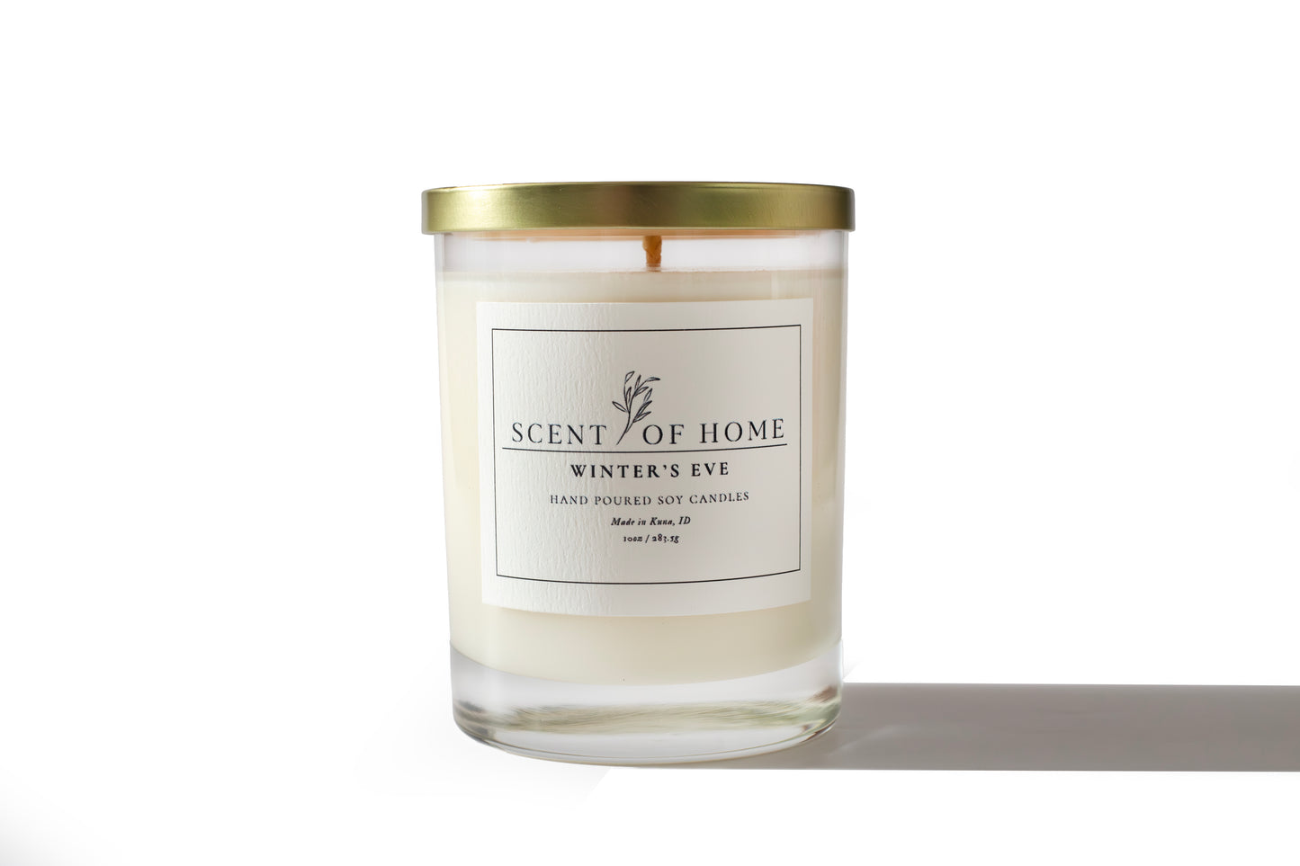 Scent of Home Winter’s Eve 10 oz hand-poured soy candle with gold lid, displayed on a white background highlighting its clean label and minimalist design.