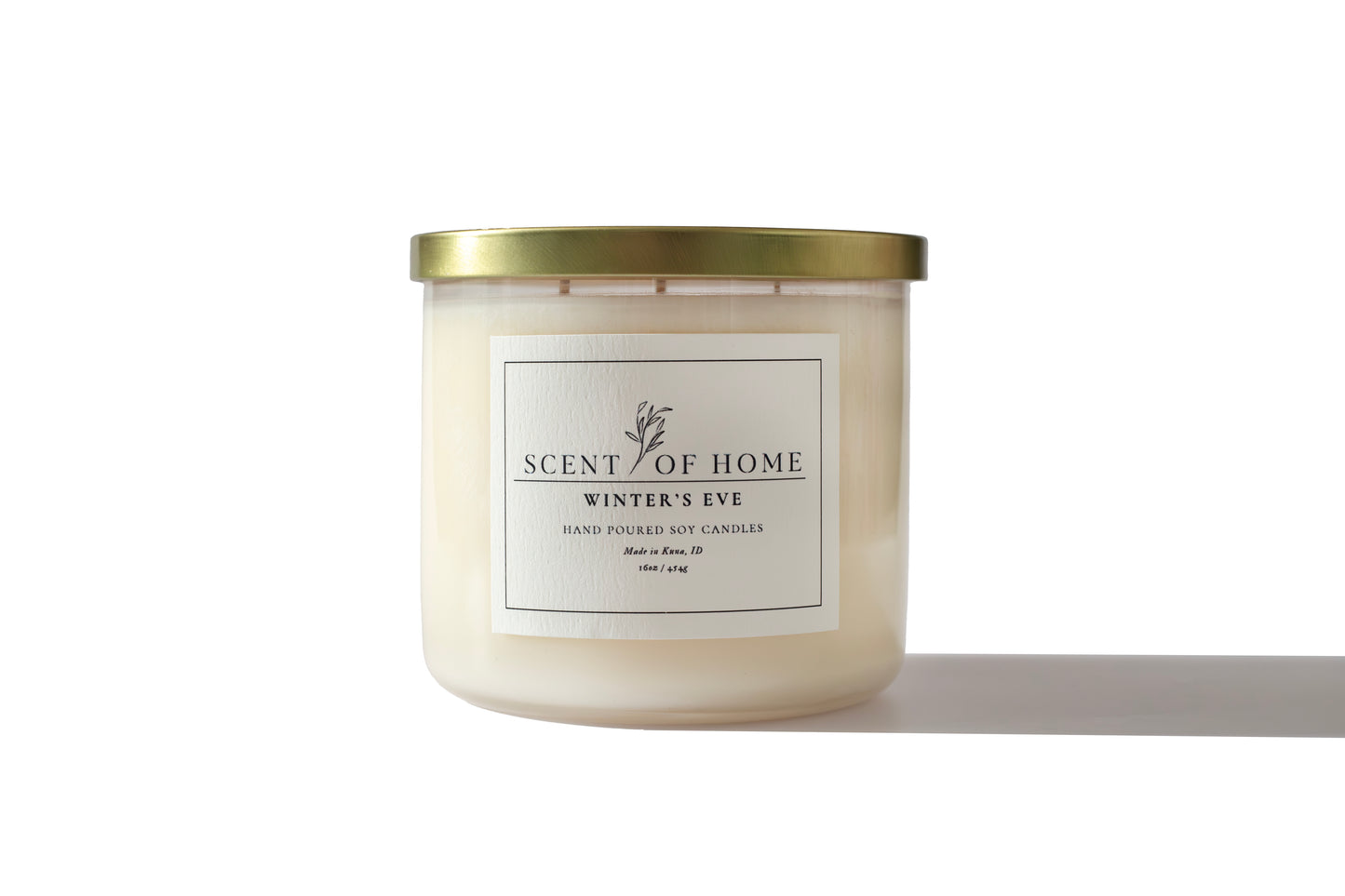 Scent of Home Winter’s Eve 16 oz three-wick soy candle with gold lid, photographed on a white background showcasing its minimalist label and clean design.