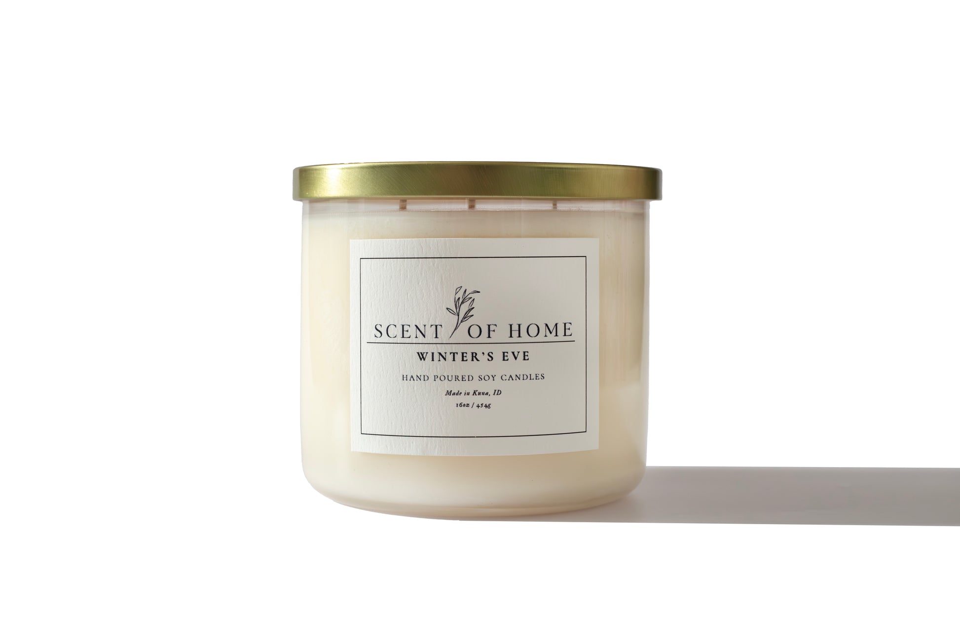 Scent of Home Winter’s Eve 16 oz three-wick soy candle with gold lid, photographed on a white background showcasing its minimalist label and clean design.